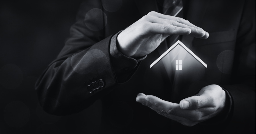 Hands of a man cradling image of house to protect