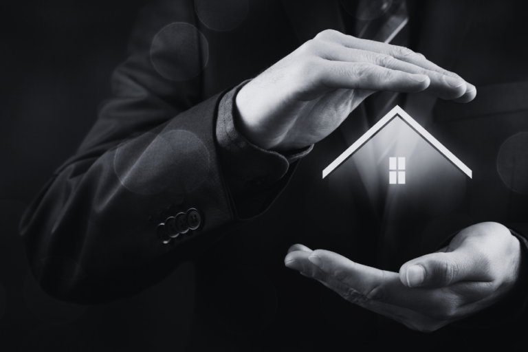 Hands of a man cradling image of house to protect