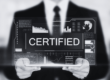 Man holding digital screen with the word certified