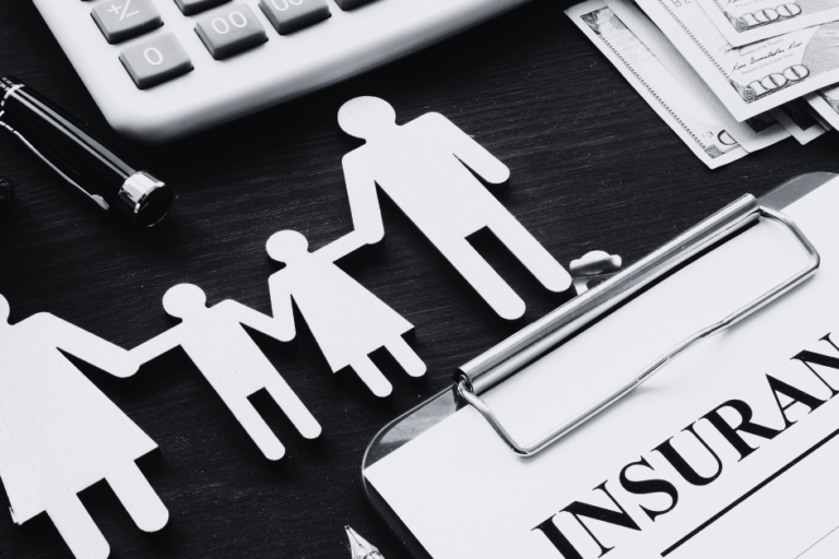 insurance policy form with icons of family holding hands representing insurance coverage on desk