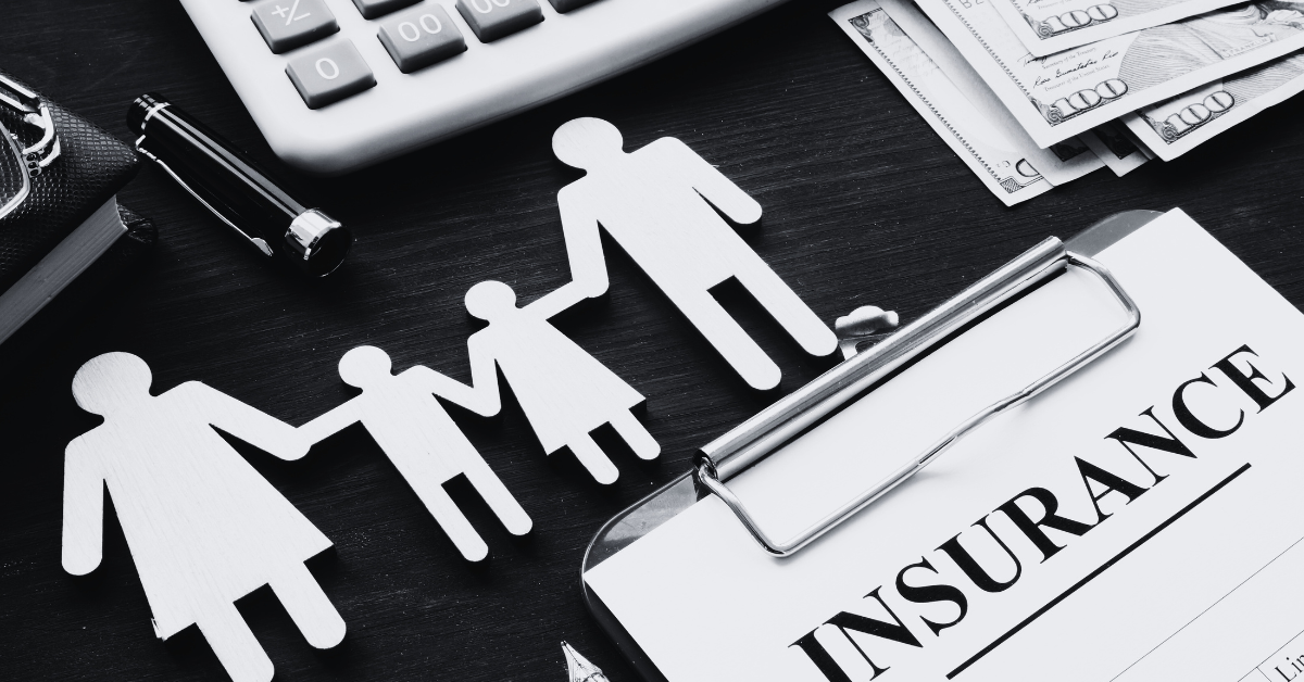 insurance policy form with icons of family holding hands representing insurance coverage on desk