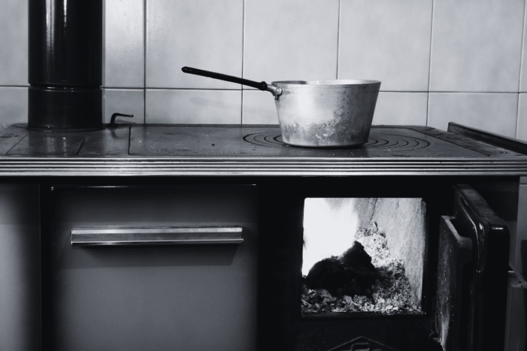 Old wood burning stove with cooking pot on stovetop