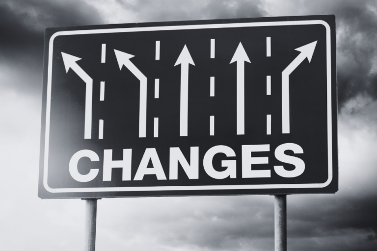 Road sign with multiple lanes showing changes in direction