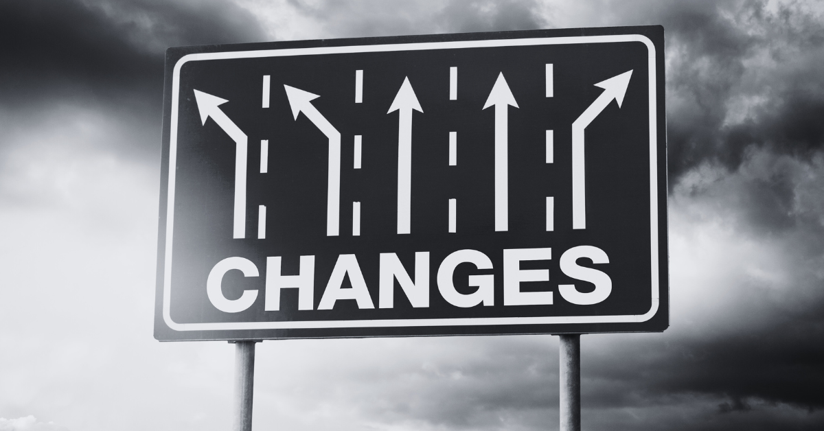 Road sign with multiple lanes showing changes in direction